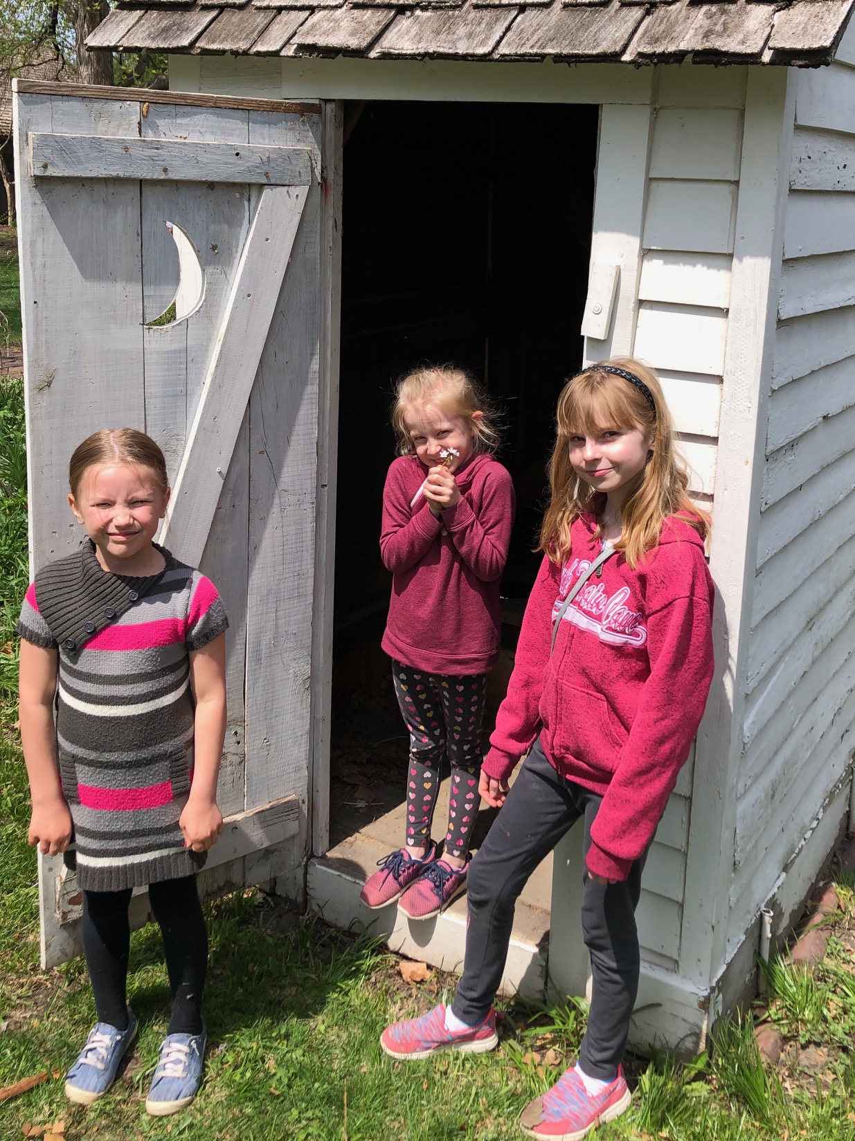 Galesburg area 4th-graders visit the "backhouse"  behind Carl Sandburg's Birthplace Cottage during the April 2019 Penny Parade program.